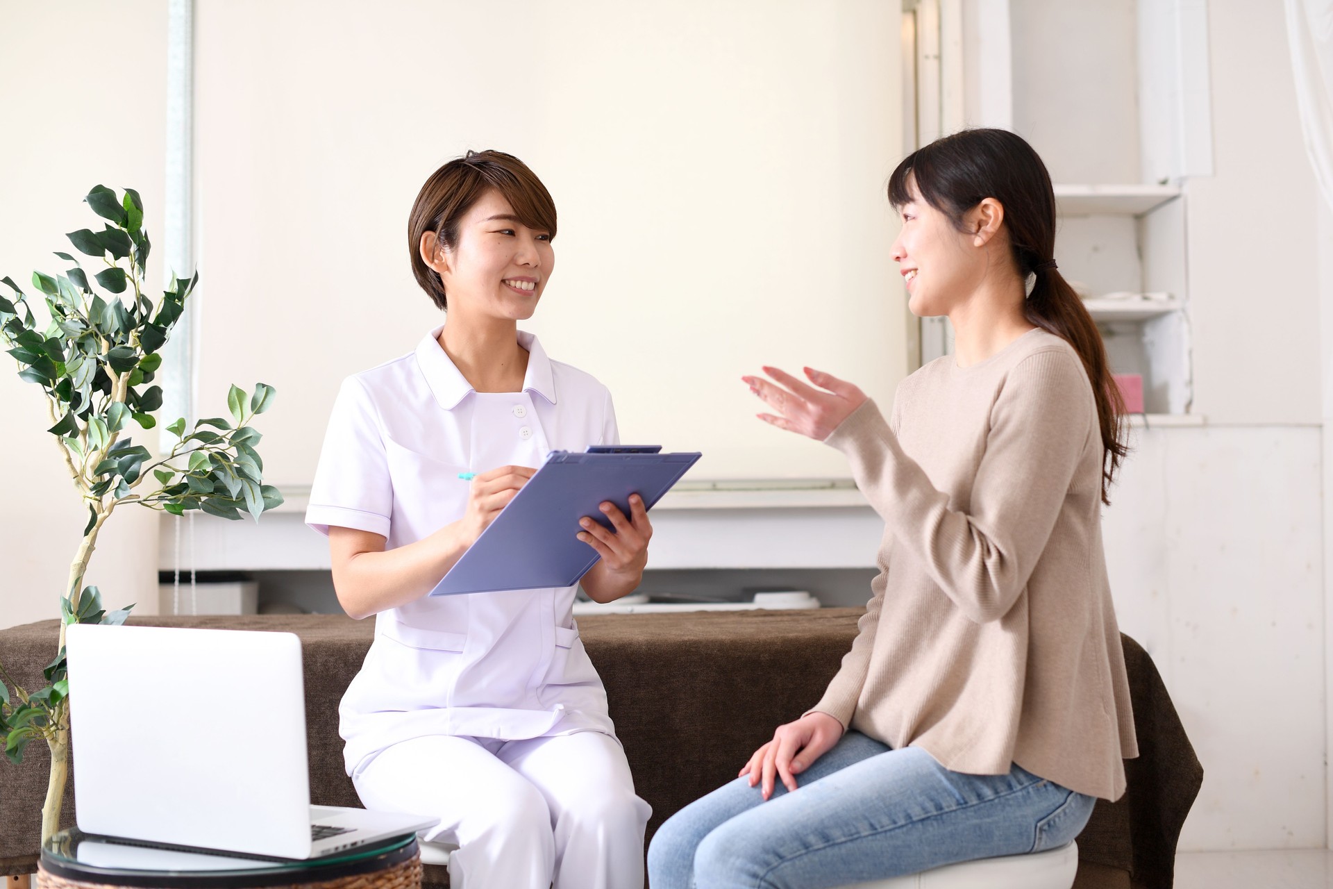 Young Asian medical worker and female patient counseling